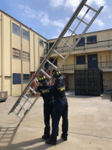 Image of two WFPA participants maneuvering a ladder